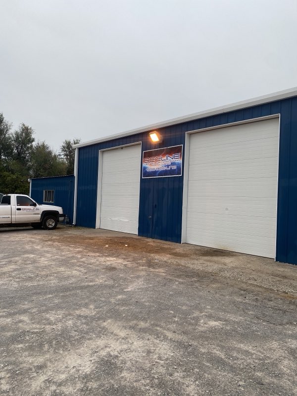 The blue Bee Line shop building with service bays in Enid